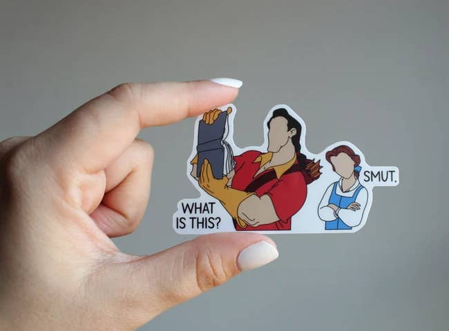 a sticker of gaston holding up belle's book saying 