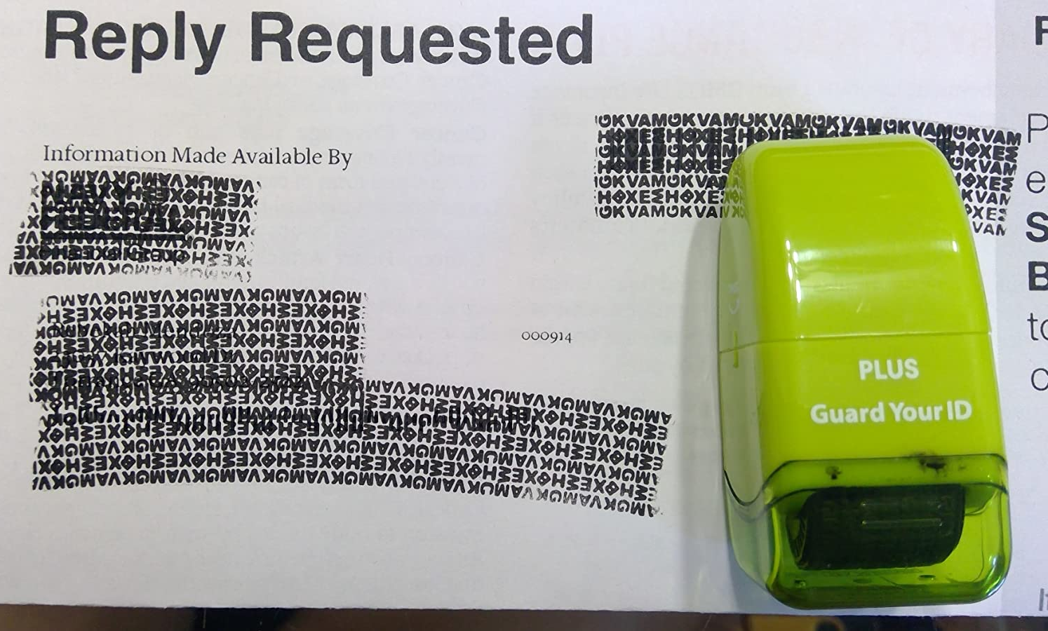 reviewer photo of a piece of mail with their name, address, and other personal information stamped out, with the green roller resting on the mail