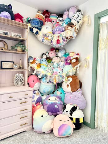 Plush toys displayed connected  shelves and a hammock successful  a cozy room, alongside a dresser with decorative items