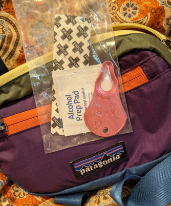 reviewer's hiking tick pack on top of bag