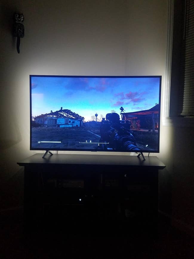 reviewer photo of the backlight kit installed on a TV monitor, making the video game on screen appear sharper
