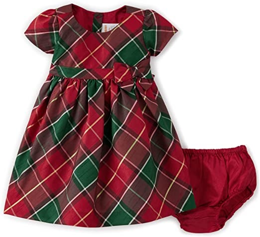 a red, gold, and green plaid short-sleeve dress and red satin diaper cover