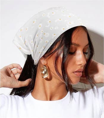model in a white floral headscarf 