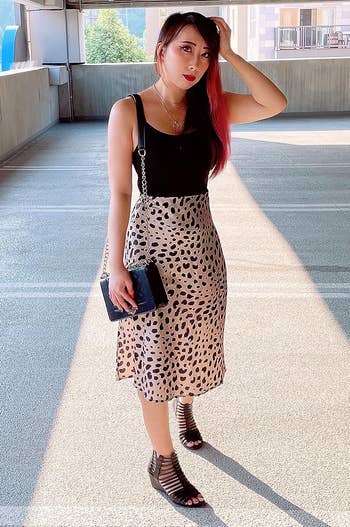 reviewer wearing the leopard print skirt