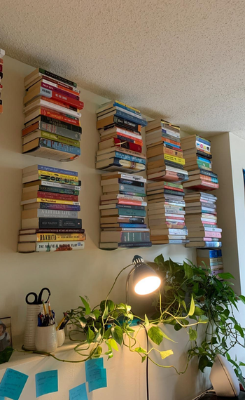 another reviewer covers the wall in books with the floating shelves