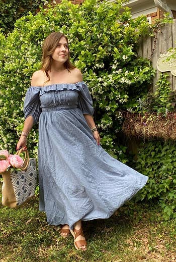 a reviewer wearing the dress in blue 