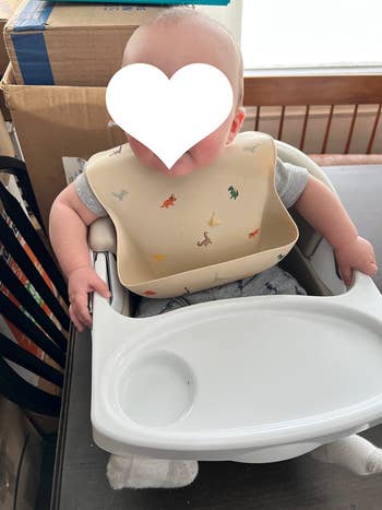 reviewer photo of baby wearing the bib
