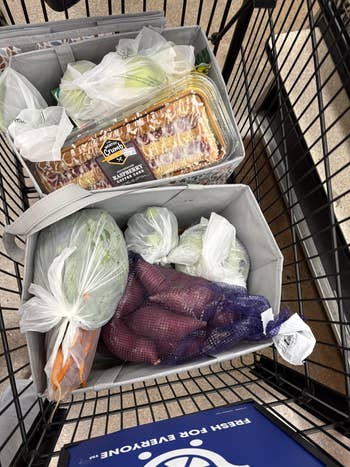 Grocery cart filled with caller nutrient similar carrots, broccoli, and cabbage, positive breadstuff and a packaged cake, placed successful reusable bags