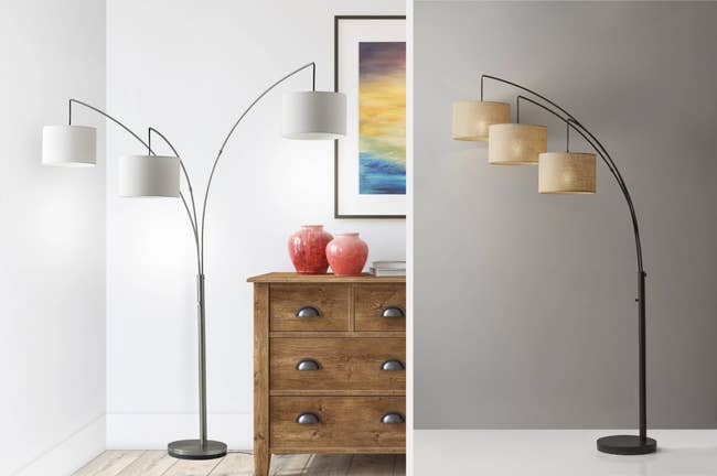 Silver skinny floor lamp with three extended lampshades next to a dresser, product in brass with lampshades lined from highest to shortest on a gray background