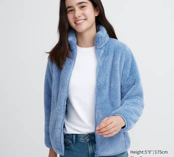model wearing blue jacket unzipped