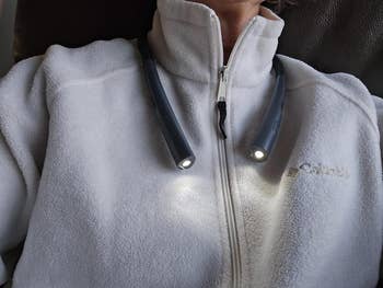 Person wearing a airy  grey  fleece with a neck-worn speechmaking  light, showcasing a cozy and functional accessory for speechmaking  oregon  tasks