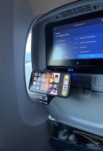 reviewer's black mount attached to back of airplane seat