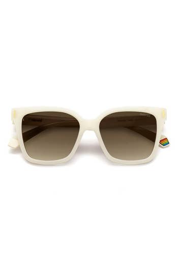 Pair of white-framed Polaroid sunglasses with dark lenses on a plain background