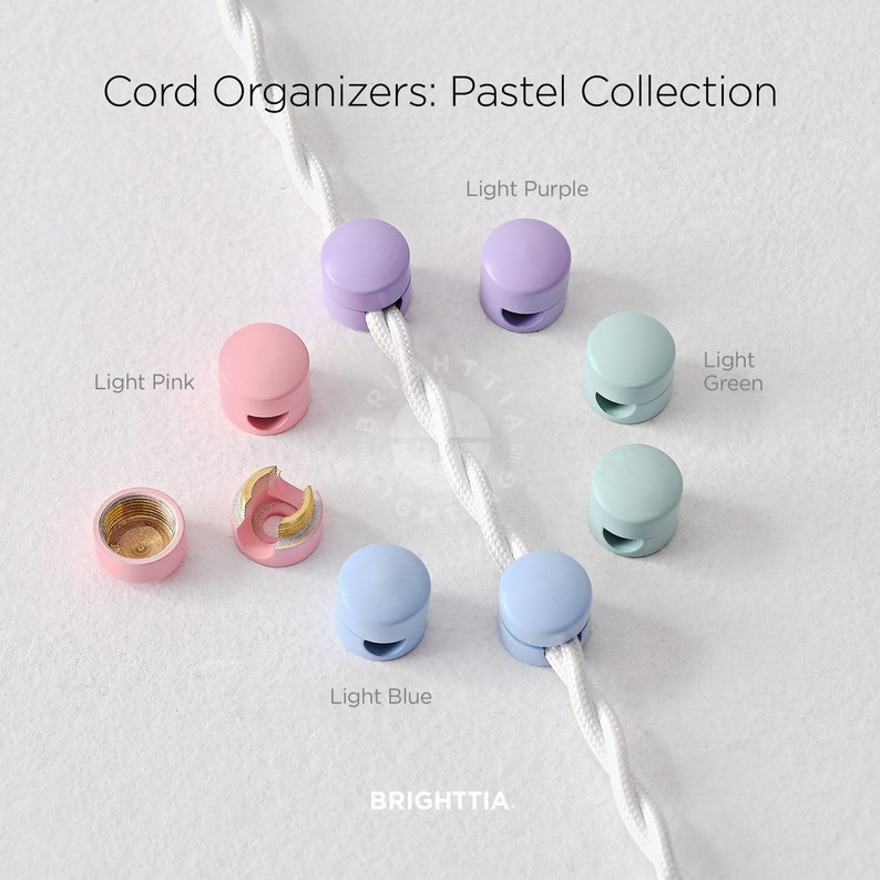 Pastel cord organizers in pink, purple, green, and blue, shown in use securing a white cord. Labeled: 