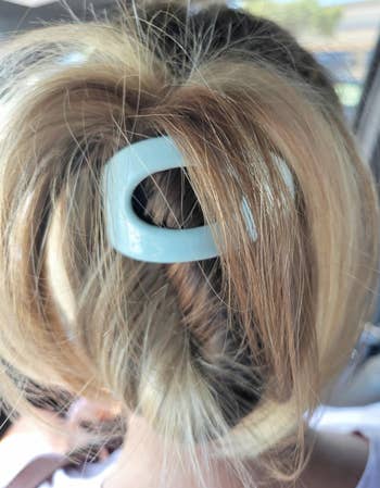Hair styled in an updo secured with a large, simple hair clip