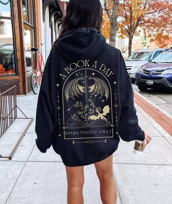 Person wearing oversized hoodie with 