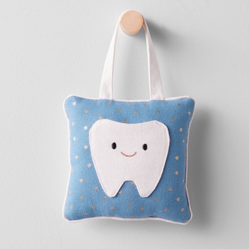 square blue and white pillow with star print and door hanger strap with a pocket shaped like a smiling tooth