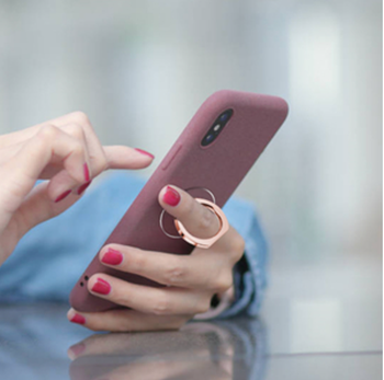 Model with a phone propped in their hand with their finger through the ring in the back 