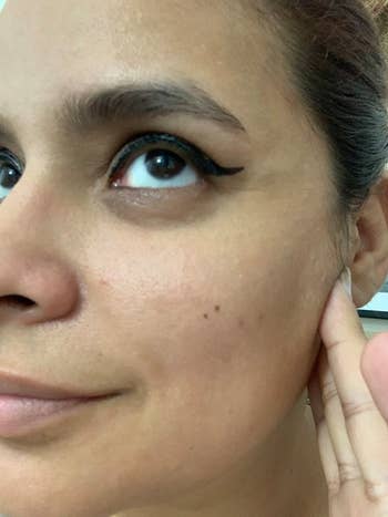 Close up of side of reviewer's face showing the winged eyeliner