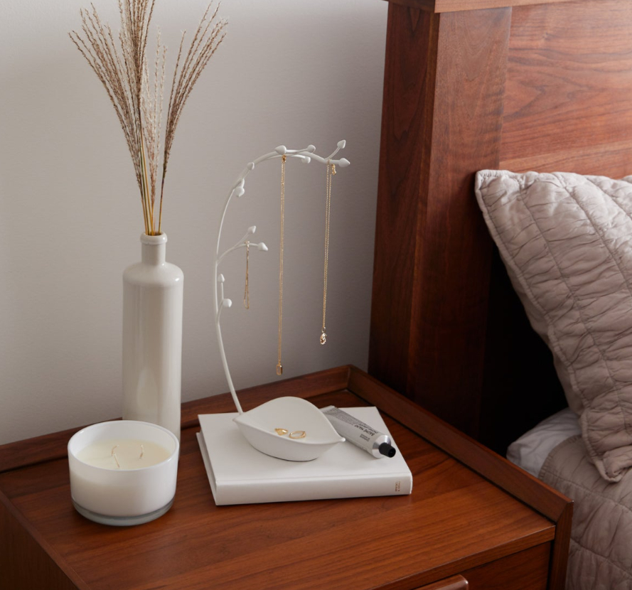white orchid jewelry stand on nightstand