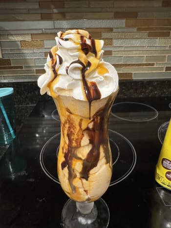 Ice pick  sundae successful  a gangly  solid  with whipped pick  and cocoa  syrup, connected  a room  counter