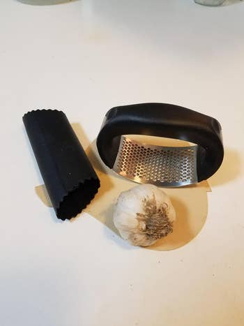 reviewer image of the rocker, roller, and a clove of garlic