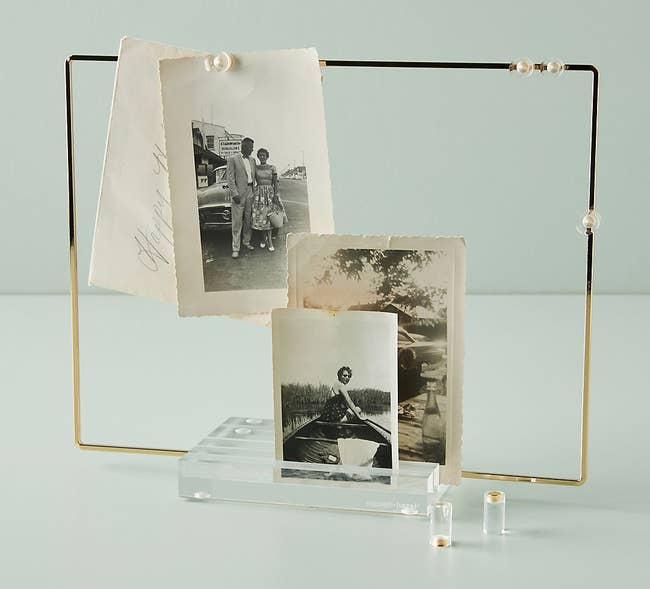 the square acrylic display with cold edge and magnets to hang photos and notes