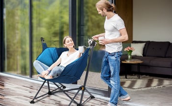 lifestyle image of model sitting in swinging camping chair
