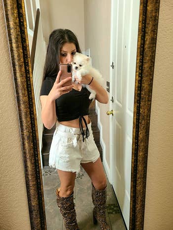 reviewer in same crop top in a black color and high-rise white shorts