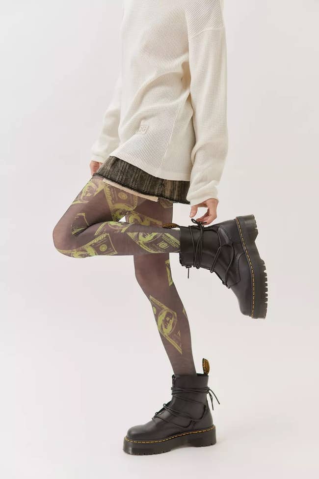model wearing tights that have a dollar bill print on them