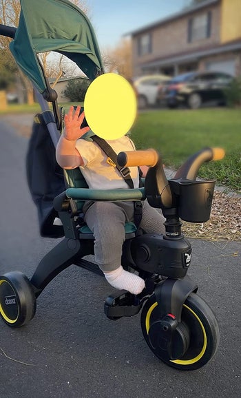 A child riding the trike