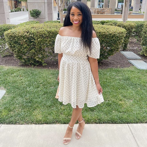 reviewer facing the camera posing with the heels on