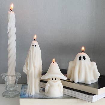 three of the soy wax candles in different ghostly designs 