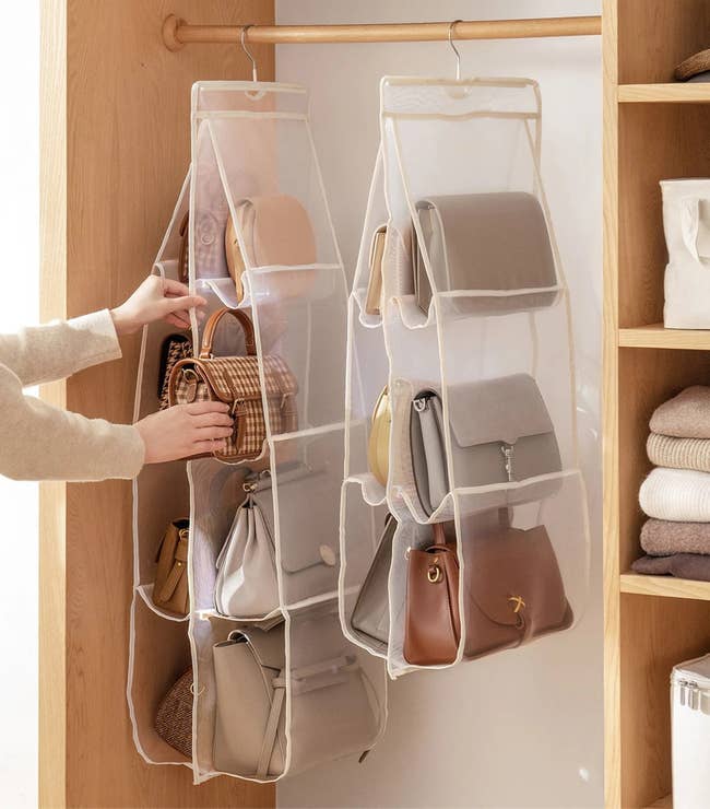 Handbags hanging in a handbag organizer, in closet