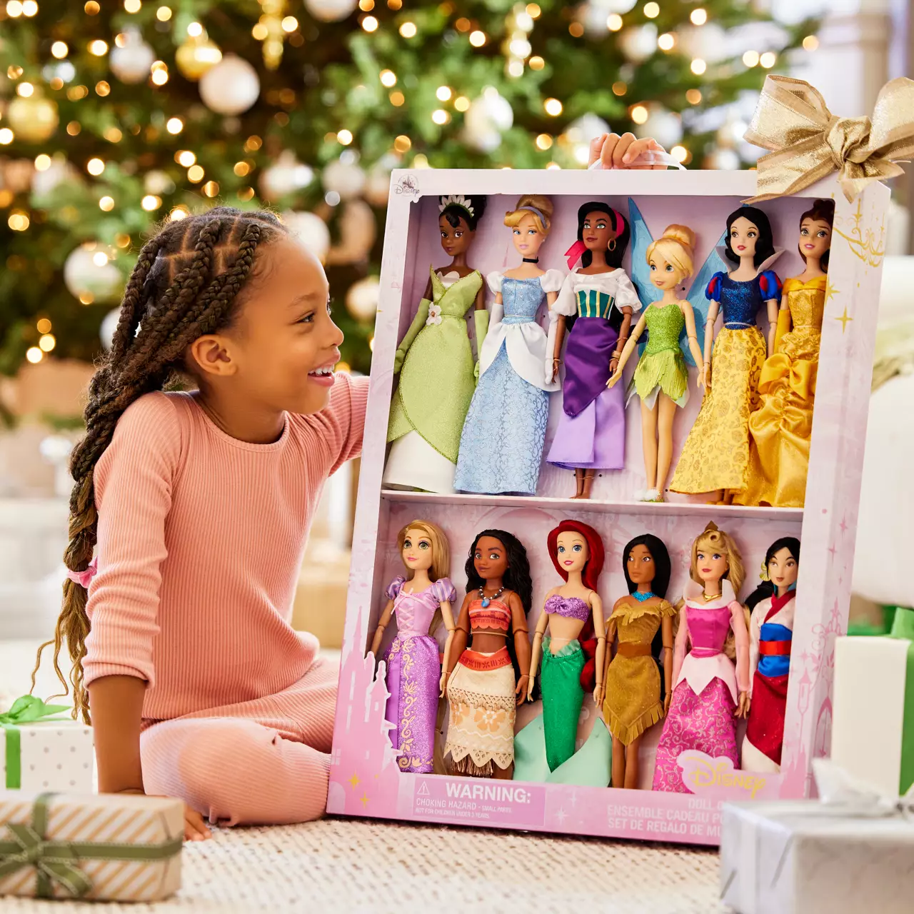 a child opening a set of Disney Princess dolls