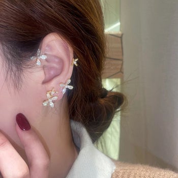 person with the ear cuff fitting onto ear