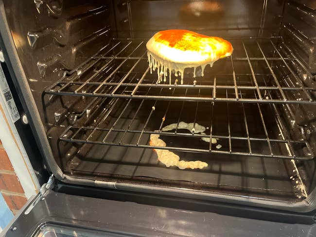 Pizza baking successful an oven, food dripping and melting onto the rack below