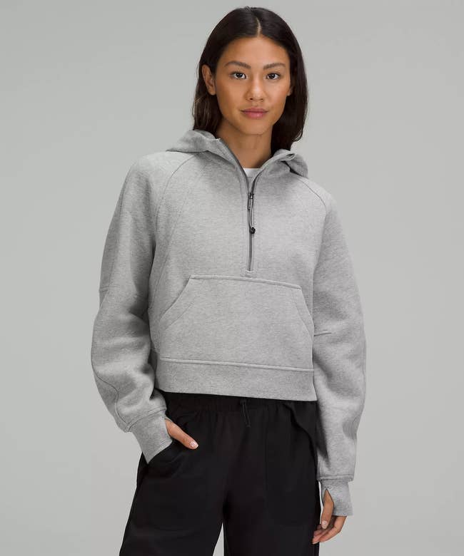 model wearing the hoodie in light grey 