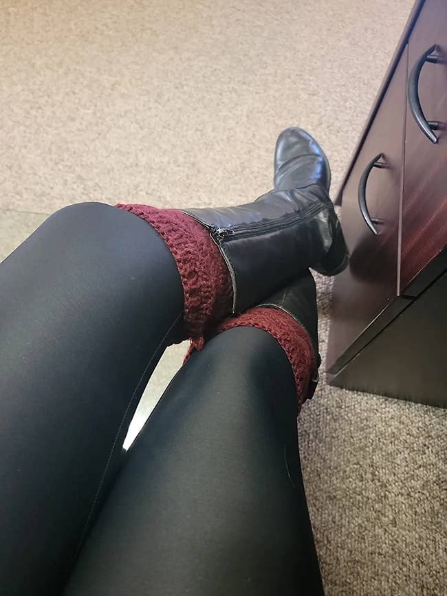 reviewer's legs with burgundy boot cuffs and black boots