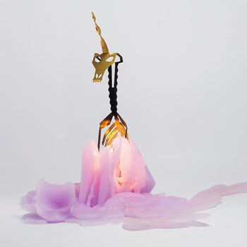 the melted purple unicorn candle revealing its metal skeleton interior