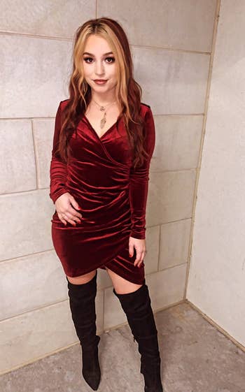 reviewer wearing the red dress with black boots 