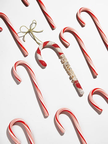 a candy cane ornament with the name 