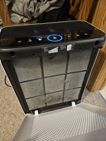 Air purifier with unfastened beforehand panel, showing the filter inside, demonstrating however to alteration oregon cleanable the filter for optimal performance