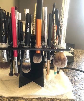 The makeup brush rack, with brushes upside down for drying