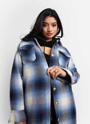 close up of model in blue plaid midi shacket