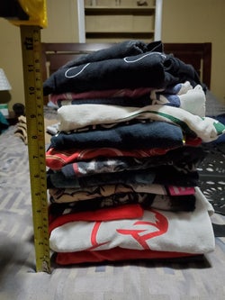 reviewer's stack of tees folded without the board, just under 11 inches tall