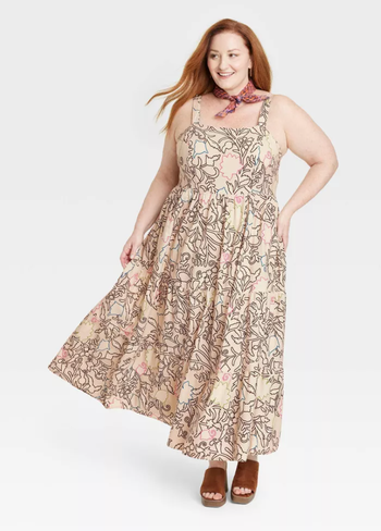 model in the tan and black floral maxi dress