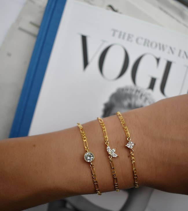 model showing three gold chain bracelets with different shaped cz charm options — round, square, and petal