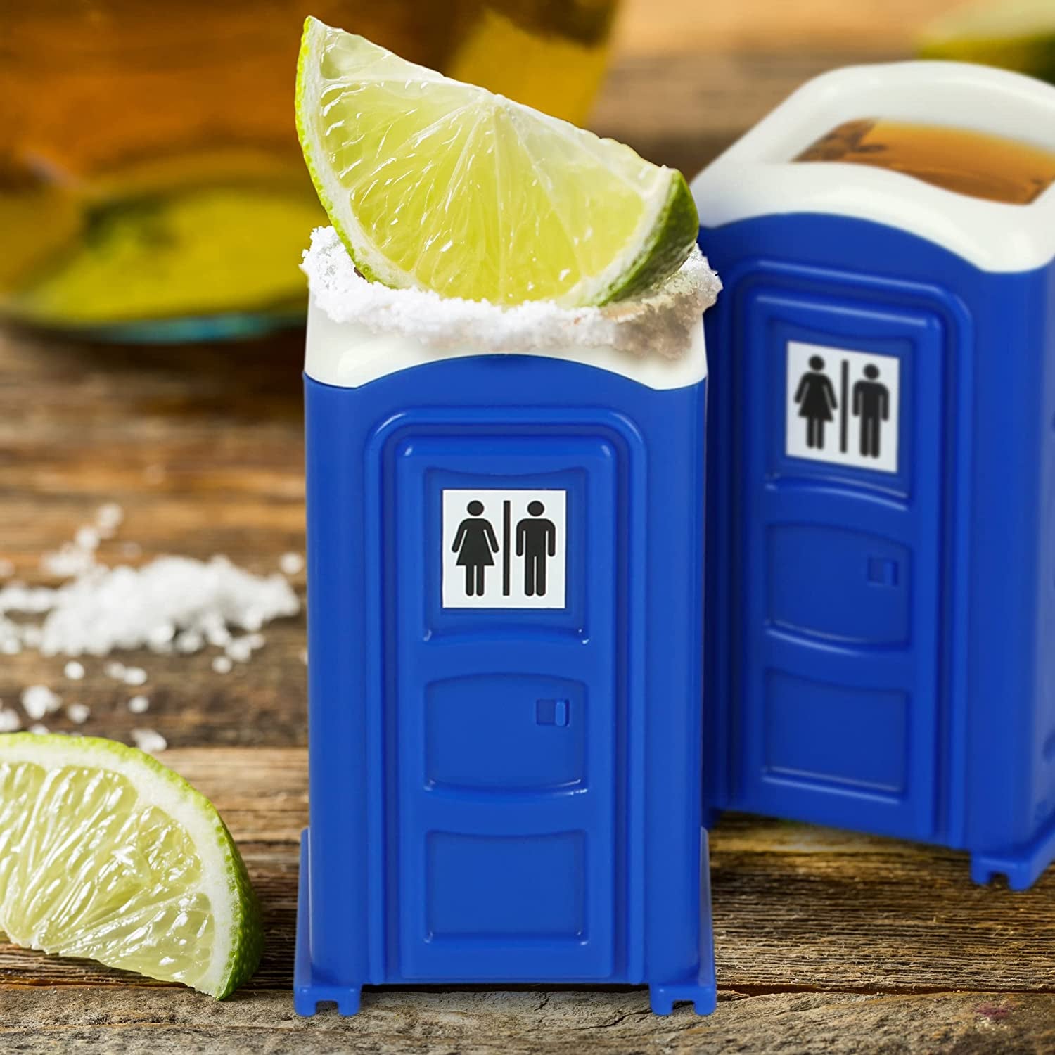 two blue porta potty shot glasses with tequila in them