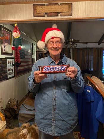 Reviewer holding a giant Snickers bar, smiling